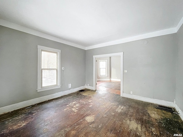 empty room with dark hardwood / wood-style floors and a wealth of natural light