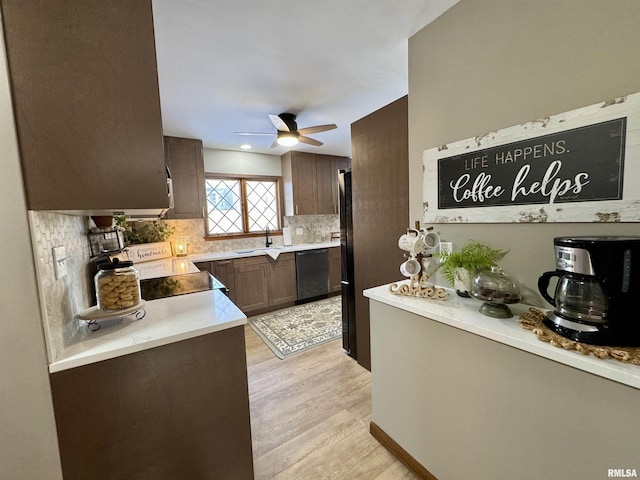 kitchen featuring backsplash, ceiling fan, dishwasher, range, and light hardwood / wood-style floors