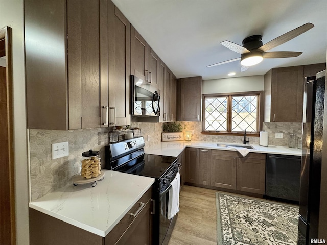 kitchen featuring black appliances, sink, ceiling fan, decorative backsplash, and light hardwood / wood-style floors