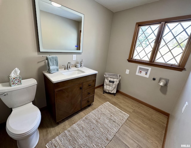 bathroom featuring vanity, toilet, and wood-type flooring