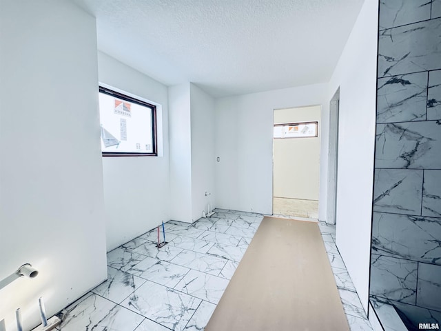 hallway with a textured ceiling