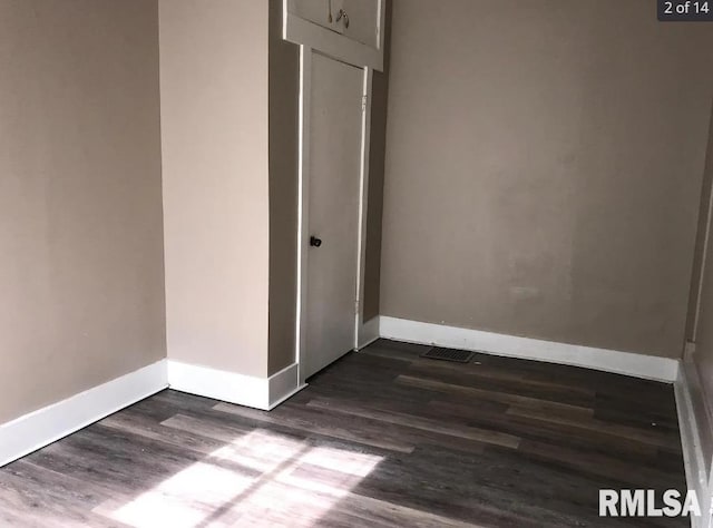 spare room with dark hardwood / wood-style floors