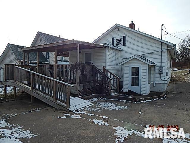 snow covered property featuring a deck