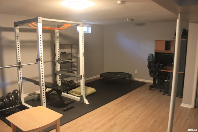 exercise room with wood-type flooring