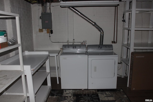 laundry area with electric panel and washing machine and dryer