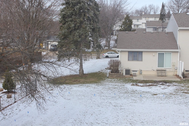 snow covered rear of property with cooling unit