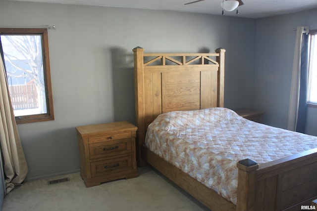 bedroom featuring ceiling fan and light carpet