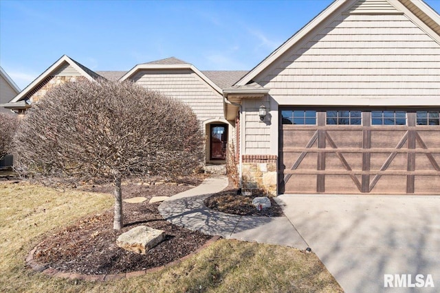 ranch-style house with stone siding, driveway, and an attached garage