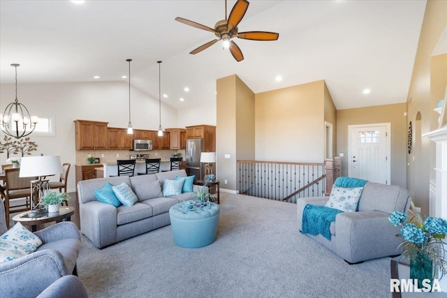 living area with carpet, baseboards, high vaulted ceiling, recessed lighting, and ceiling fan with notable chandelier