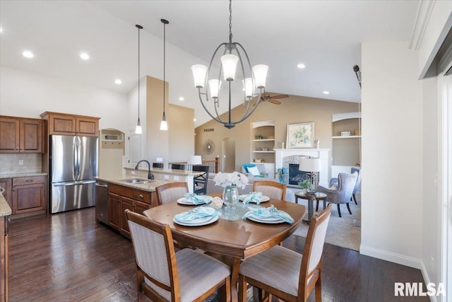 dining room with built in features, a fireplace, baseboards, and dark wood-style flooring