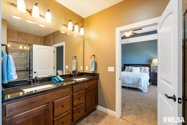 ensuite bathroom with a sink, ensuite bathroom, a ceiling fan, and a shower stall