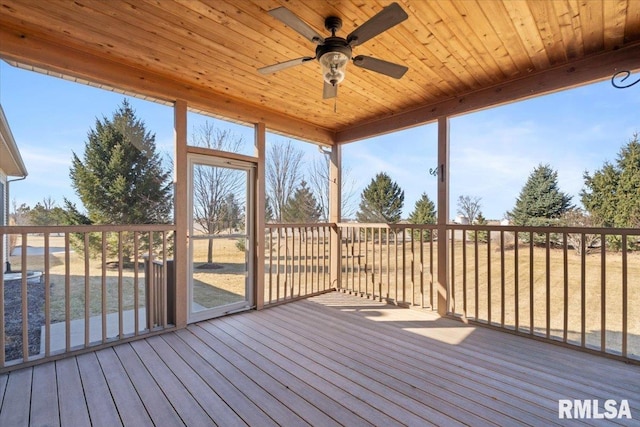 unfurnished sunroom featuring wood ceiling and a ceiling fan