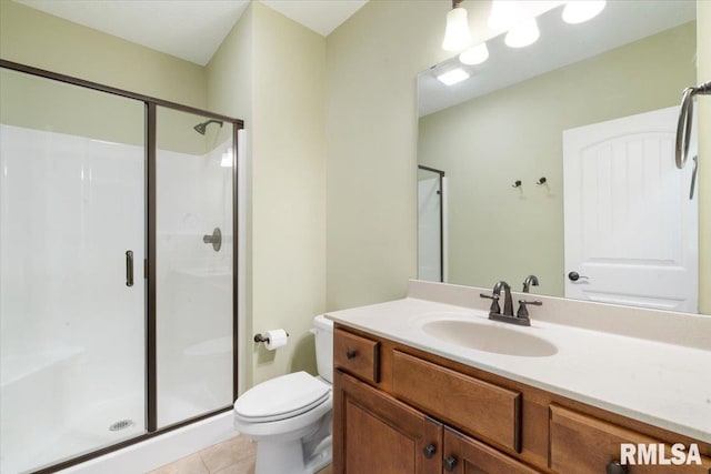 full bathroom featuring tile patterned flooring, a shower stall, toilet, and vanity