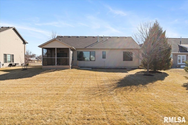 back of house featuring a lawn and a sunroom