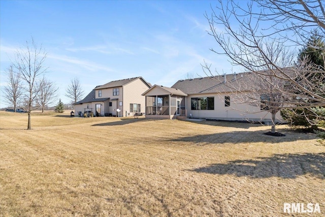 rear view of house with a lawn