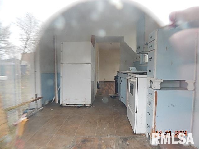 kitchen with white cabinets and white appliances