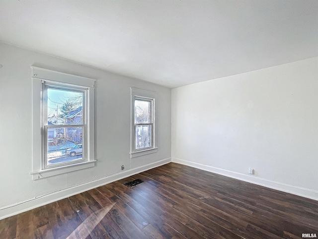 empty room featuring dark hardwood / wood-style flooring