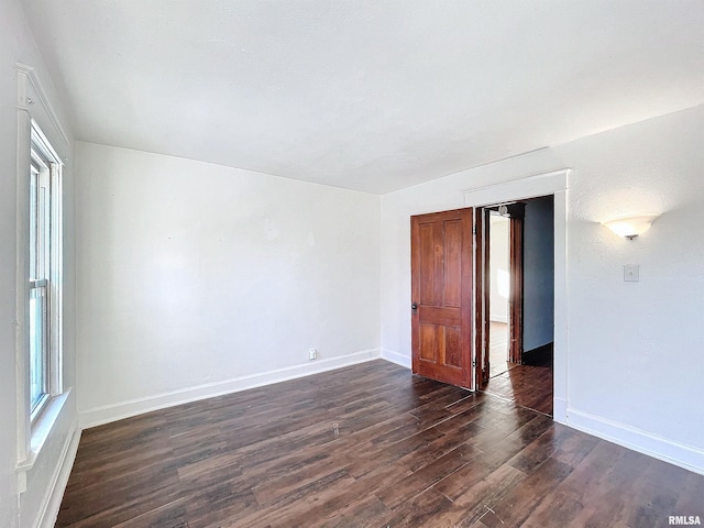 unfurnished room featuring dark hardwood / wood-style flooring