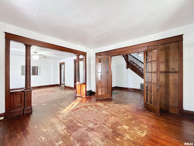 unfurnished room featuring french doors, ornate columns, hardwood / wood-style flooring, and ceiling fan