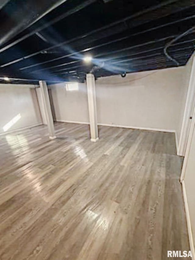 basement with hardwood / wood-style flooring