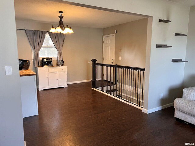 2433 Cedar Creek Ct, Quincy, IL 62305 - hallway with dark hardwood / wood-style flooring and a chandelier