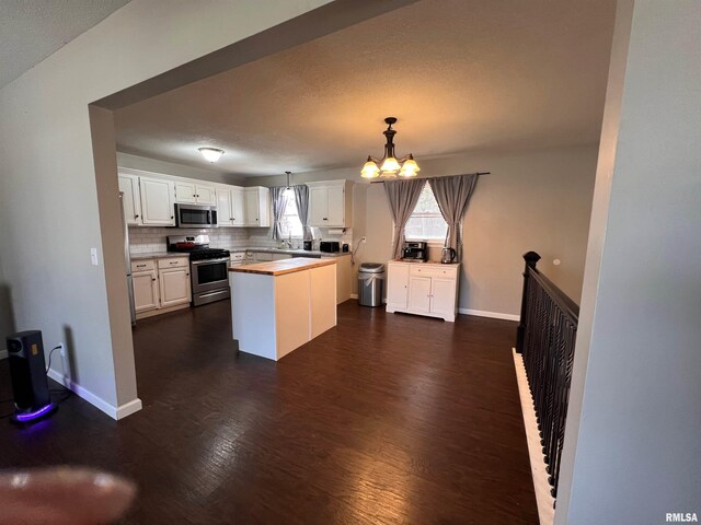 2433 Cedar Creek Ct, Quincy, IL 62305 - kitchen featuring white cabinetry, butcher block counters, stainless steel appliances, a center island, and decorative light fixtures