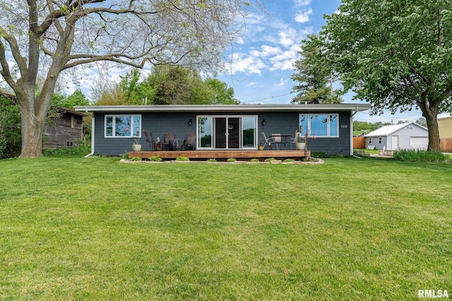 back of house featuring a yard and a deck