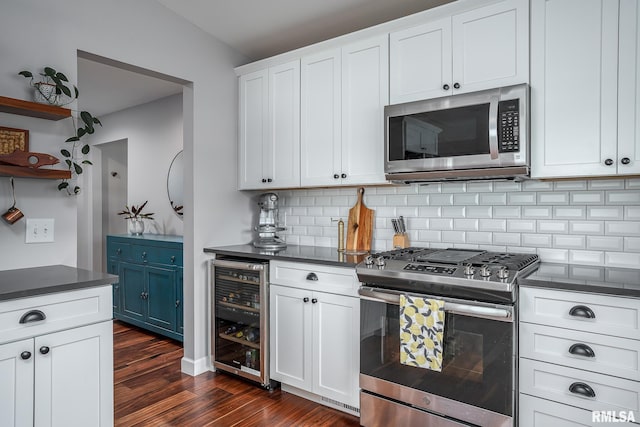 kitchen featuring backsplash, white cabinets, beverage cooler, and stainless steel appliances