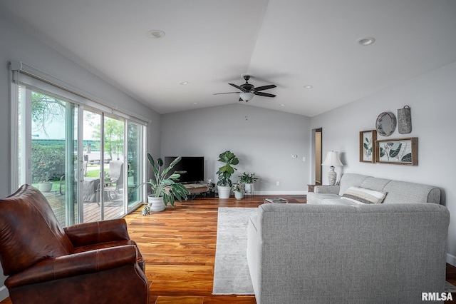 living room featuring ceiling fan, hardwood / wood-style floors, and lofted ceiling