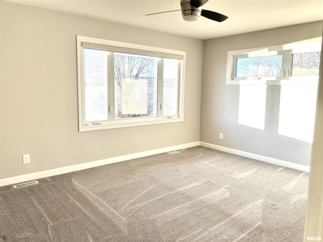 carpeted spare room with ceiling fan