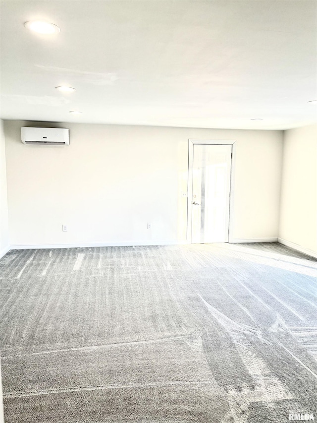 empty room featuring carpet flooring and a wall mounted AC