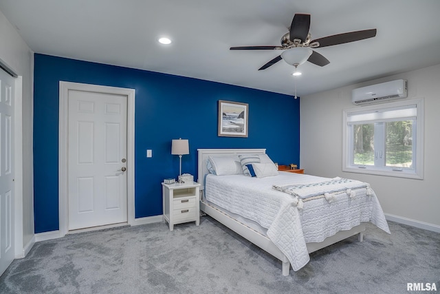 carpeted bedroom with a wall mounted air conditioner, ceiling fan, and a closet