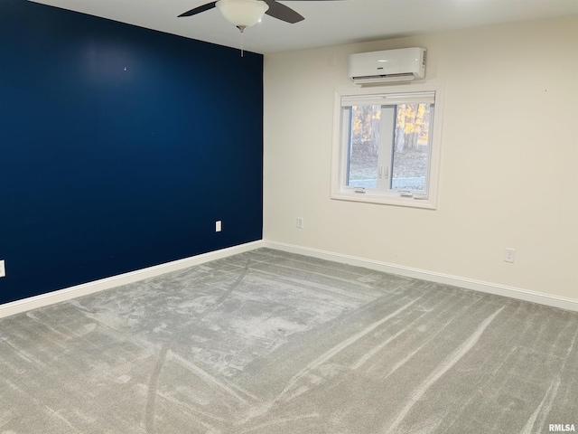 carpeted spare room featuring a wall unit AC and ceiling fan