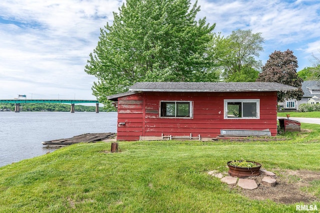 view of side of property with a water view and a lawn