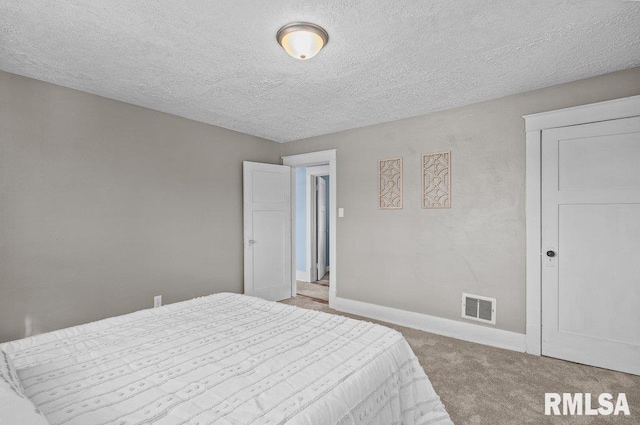 carpeted bedroom with a textured ceiling