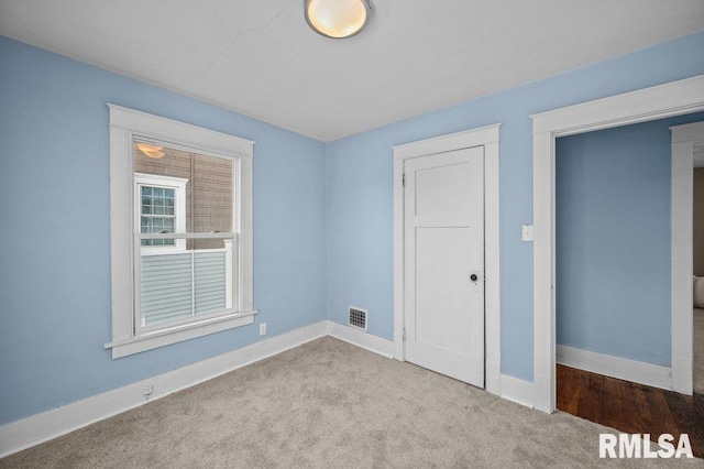 unfurnished bedroom with light colored carpet