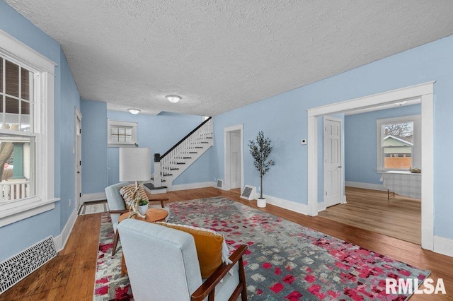 living room featuring hardwood / wood-style floors and a textured ceiling