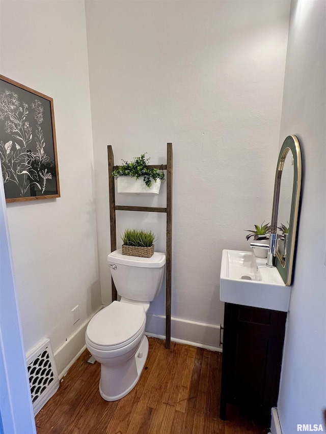 bathroom featuring hardwood / wood-style floors, vanity, and toilet