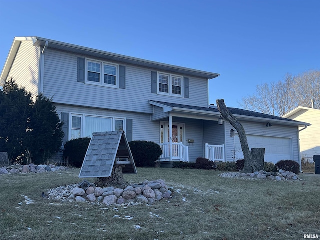 front of property featuring a front yard and a garage