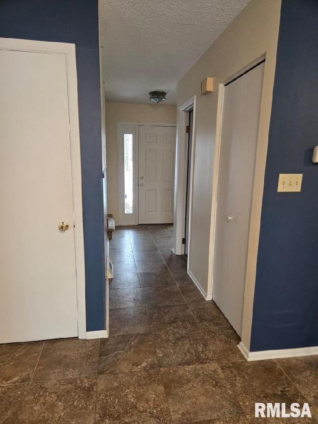 hall with a textured ceiling