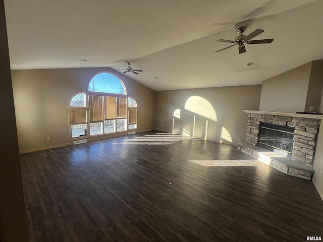 unfurnished living room with a fireplace, vaulted ceiling, ceiling fan, and dark wood-type flooring