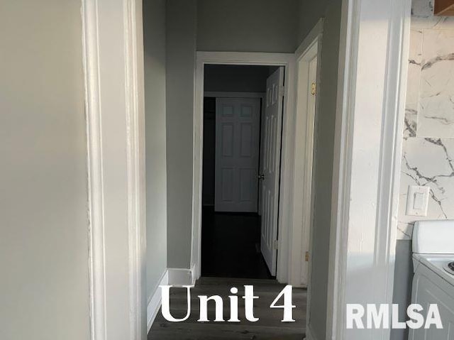 hallway with washer and clothes dryer and dark hardwood / wood-style floors