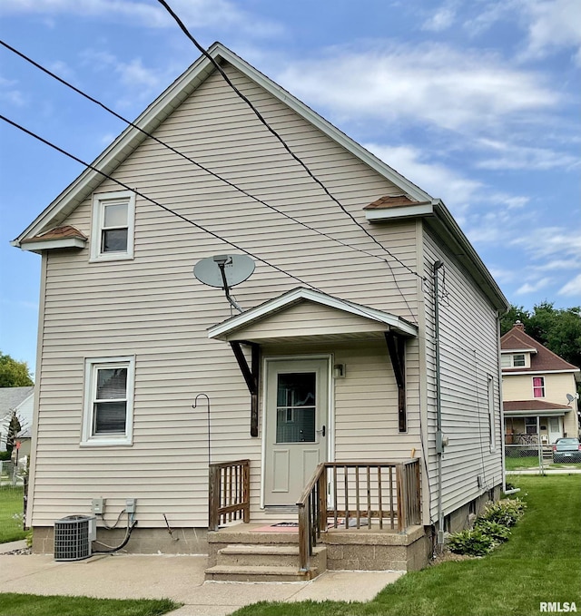 back of house featuring a yard and central AC unit