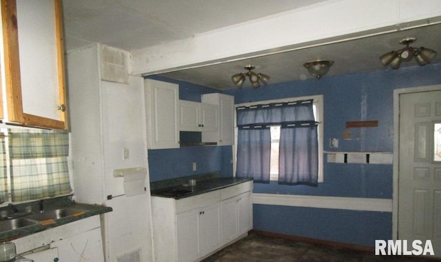 kitchen featuring extractor fan and white cabinetry