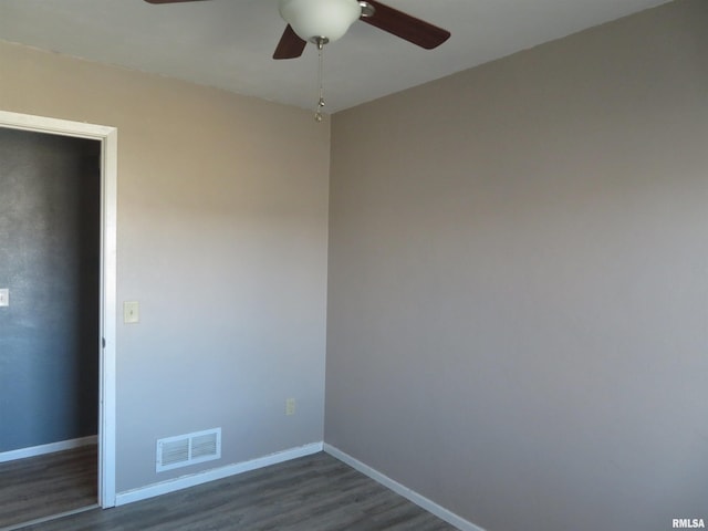 unfurnished bedroom with ceiling fan and dark wood-type flooring