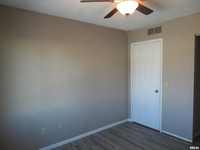 spare room featuring ceiling fan and dark hardwood / wood-style flooring