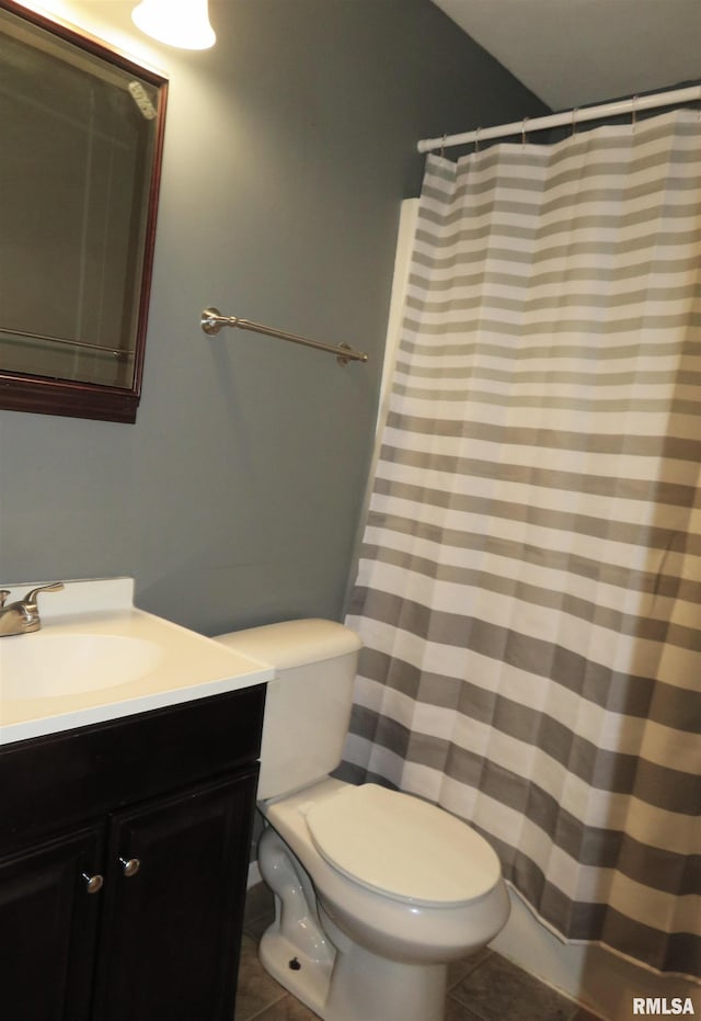 bathroom with tile patterned flooring, vanity, and toilet