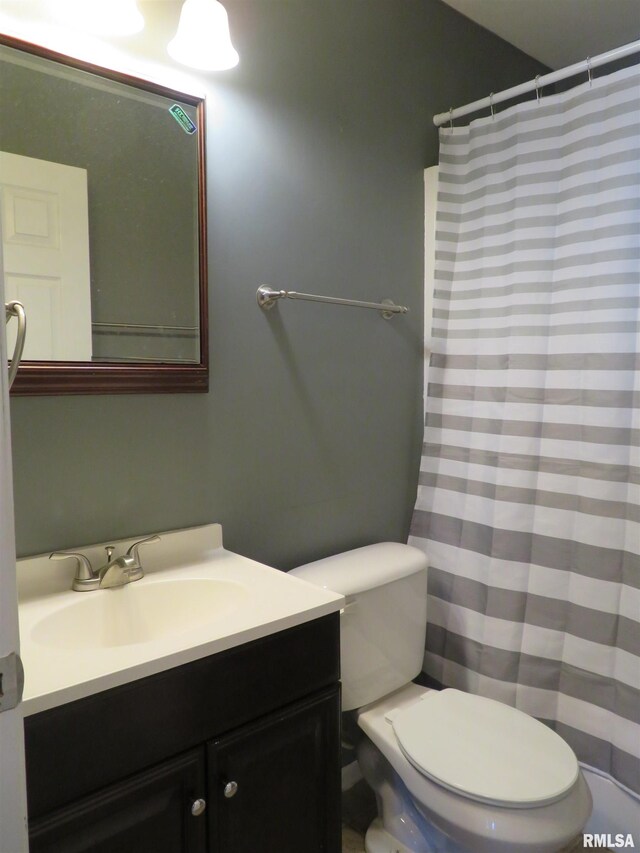 bathroom featuring tile patterned flooring, vanity, and toilet