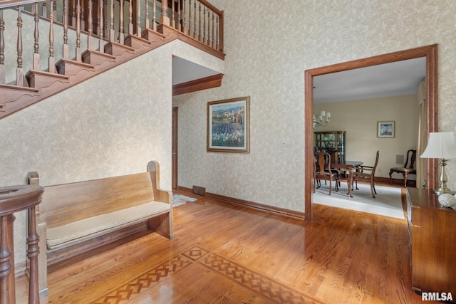 stairway featuring a chandelier and hardwood / wood-style floors