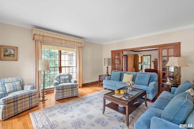 living room with light wood-type flooring and crown molding